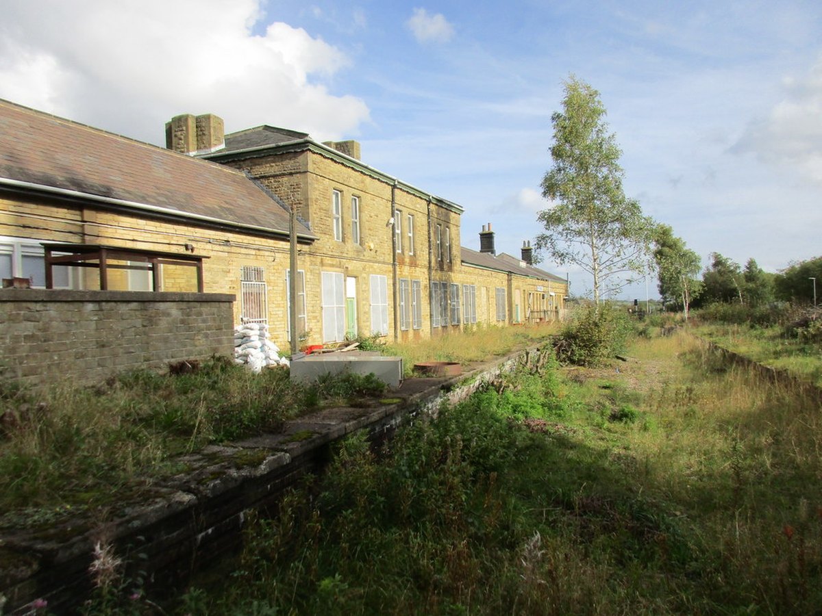 Penistone station closed and derelict today, platform overgrown and trackbed lifted.
